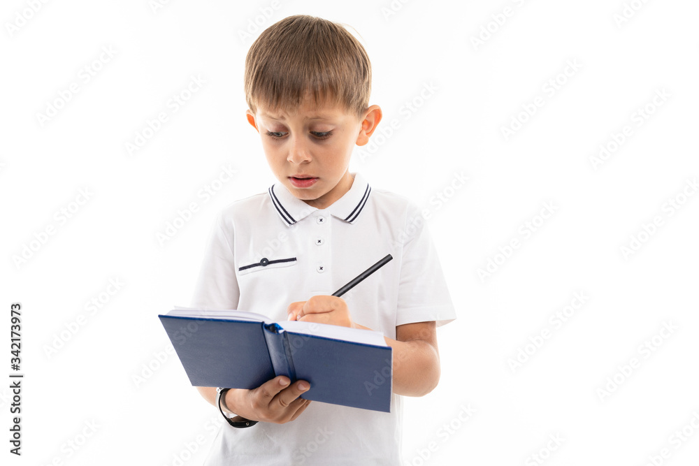 Young caucasian teenager do homework and thinks isolated on white background Young caucasian teenager do homework and thinks isolated on white background