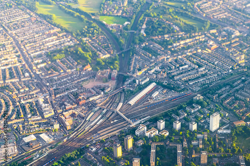 Aerial high angle view from airplane over city of London in United Kingdom with Clapham Junction train station and railroad railway tracks with depot storage warehouse buildings photo