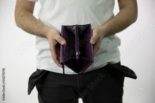 Caucasian whites men's hands show empty open wallet and empty pants pockets turned inside out isolated on white background close up . concept of poverty, cash is out