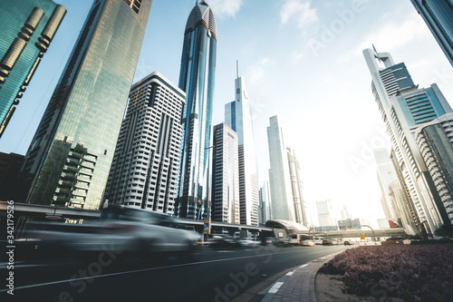 Cars passing on highway in front of skyscrapers Dubai - UAE