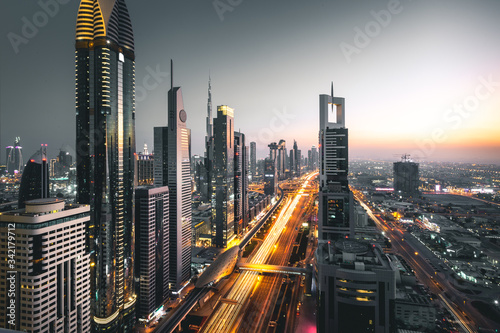 Long exposure view of traffic and skyline from rooftop at sunset Dubai - UAE