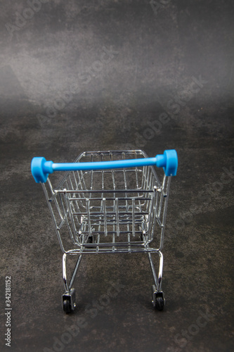 Empty Groceries trolley on grey background