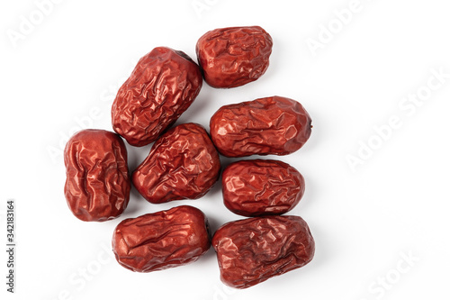 A bowl of Chinese dried red date fruit on white background.
