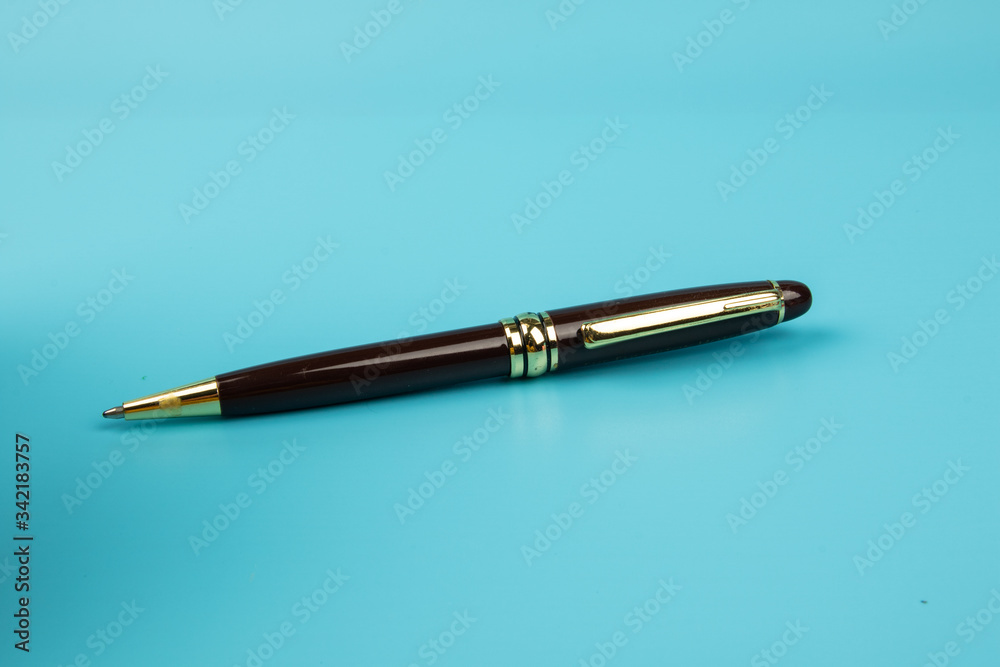 A ball pen on Blue background. A ball pen on Blue background.