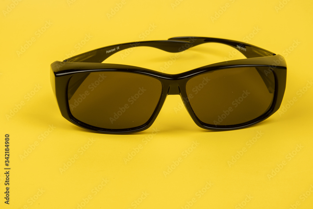 Image of Sunglasses isolated on yellow background.