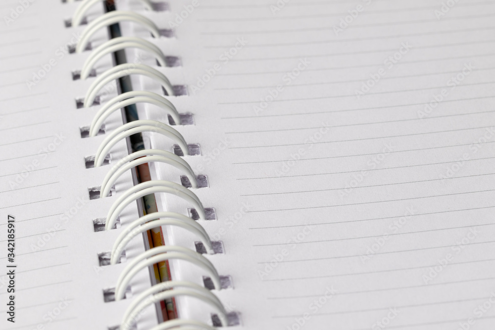Close up School book page. White empty paper spiral notebook Close up School book page. White empty paper spiral notebook