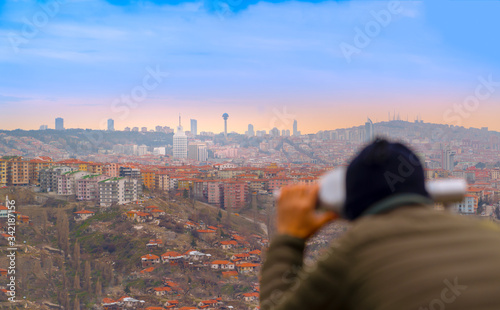 Ankara/Turkey-March 02 2019: Man watches Atakule thorough City binoculars