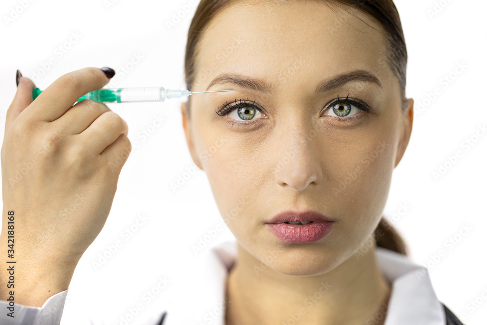 Portrait of attractive woman filling wrinkles over the upper eyelid with hyaluronic acid from syringe, white background. Cosmetology, facial botox injections, anti-aging face injections, face lifting