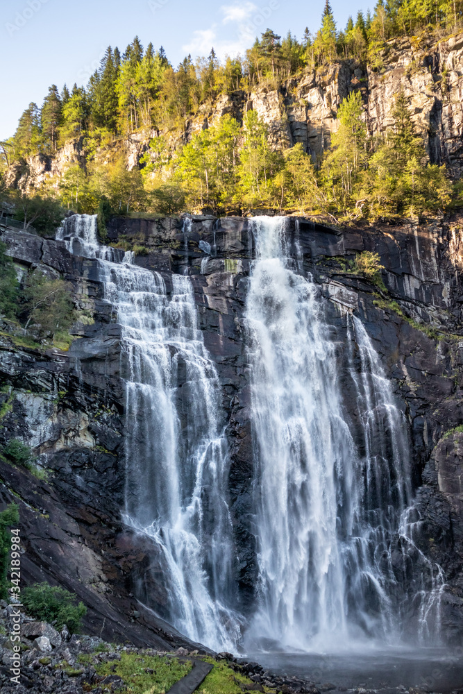 Skjervsfossen norwegian landmark high powerful cascade waterfall. Nature travel clean falling water vertical landscape 
