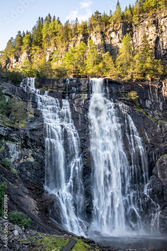 Skjervsfossen norwegian landmark high powerful cascade waterfall. Nature travel clean falling water vertical landscape 