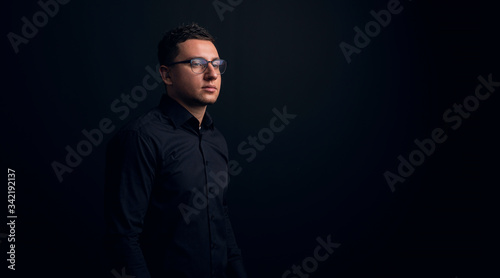 Perfect to the last detail. Handsome young businessman look into the distance on a gray background