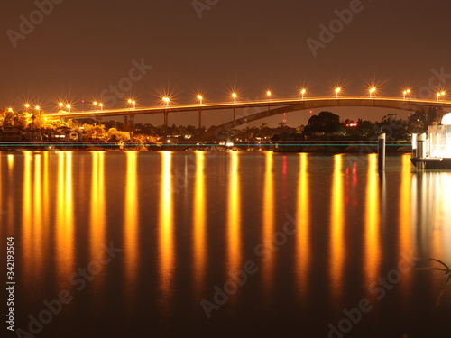 Night Long exposure of Gladesville Bridge in Sydney Australia illuminated by the bright lights and smooth harbour waters light up 