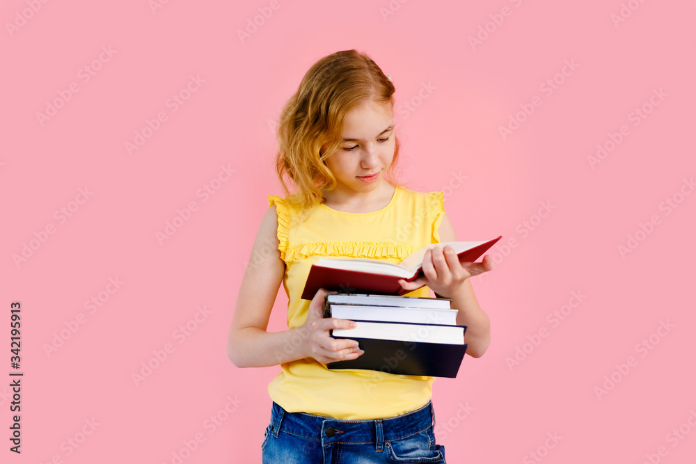 Photo of happy charming blonde girl posing with exercise books and smiling isolated over pink background Photo of happy charming blonde girl posing with exercise books and smiling isolated over pink background
