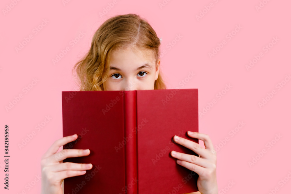 Photo of happy charming blonde girl posing with exercise books and smiling isolated over pink background Photo of happy charming blonde girl posing with exercise books and smiling isolated over pink background