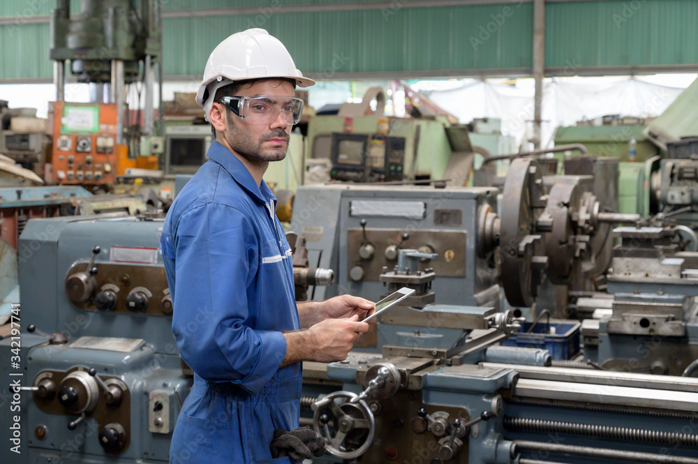 Caucasian man in uniform works hold laptop on the production. Industrial modern technology. Caucasian man in uniform works hold laptop on the production. Industrial modern technology.