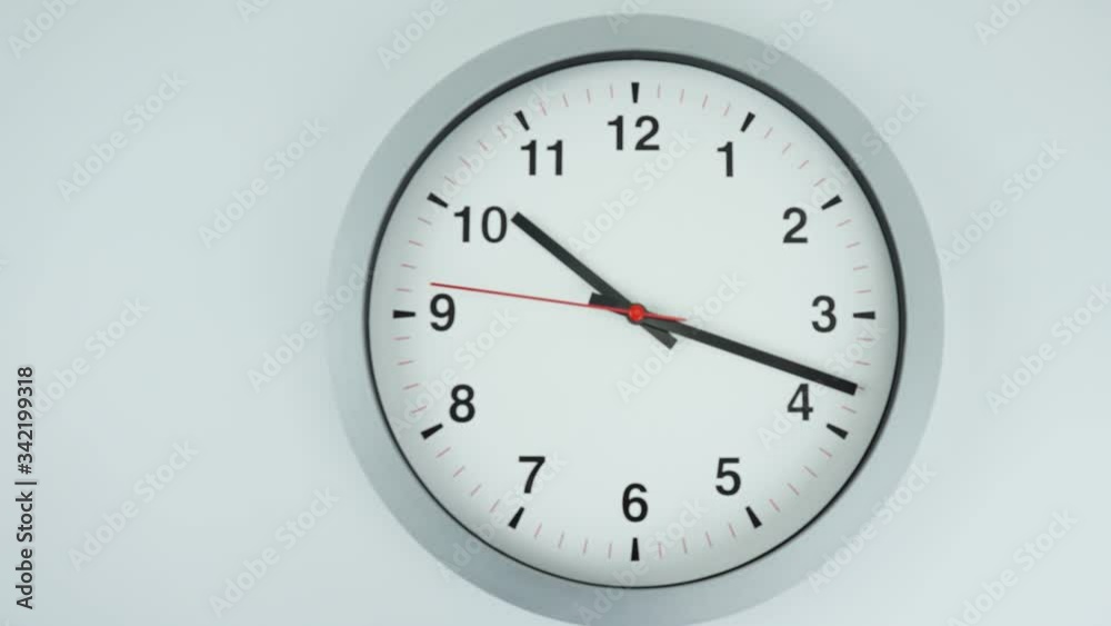 Close up Move the camera angle from right to left, Gray wall clock shows time 10 o'clock on black background, Time lapse 60 minutes moving fast, Time concept. Close up Move the camera angle from right to left, Gray wall clock shows time 10 o'clock on black background, Time lapse 60 minutes moving fast, Time concept.