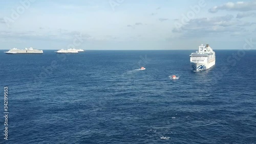 Bimini, Bahamas - 23 April 2020: meeting cruise ships in open sea to exchange provision and transferring crew photo