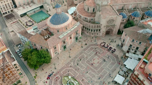 Aerial revealing shot of Basílica de la Mare de Déu dels Desemparats and Valencia Cathedral. photo