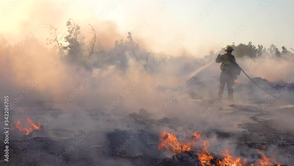 2019 - ground fire burns as firefighters battle a burning structure ...