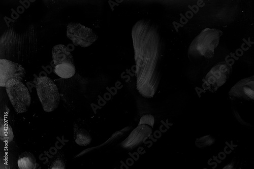 Finger Prints on solid black surface, macro shot