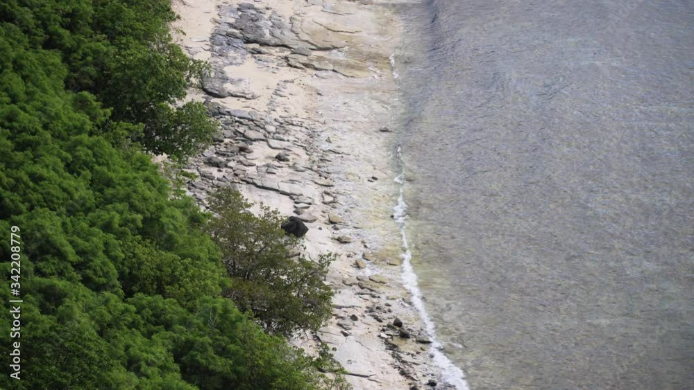 Close up of a rocky beach with calm waves rolling in, high angle landscape, 4K Close up of a rocky beach with calm waves rolling in, high angle landscape, 4K