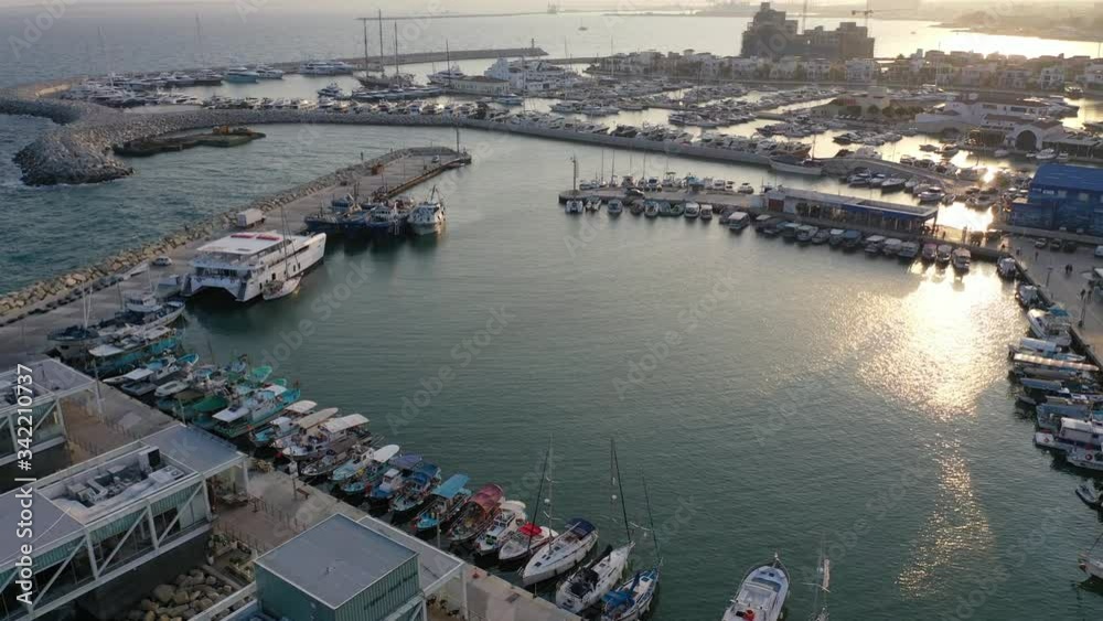 Aerial view flying over a marina in Limassol, Cyprus just as the sun is setting.