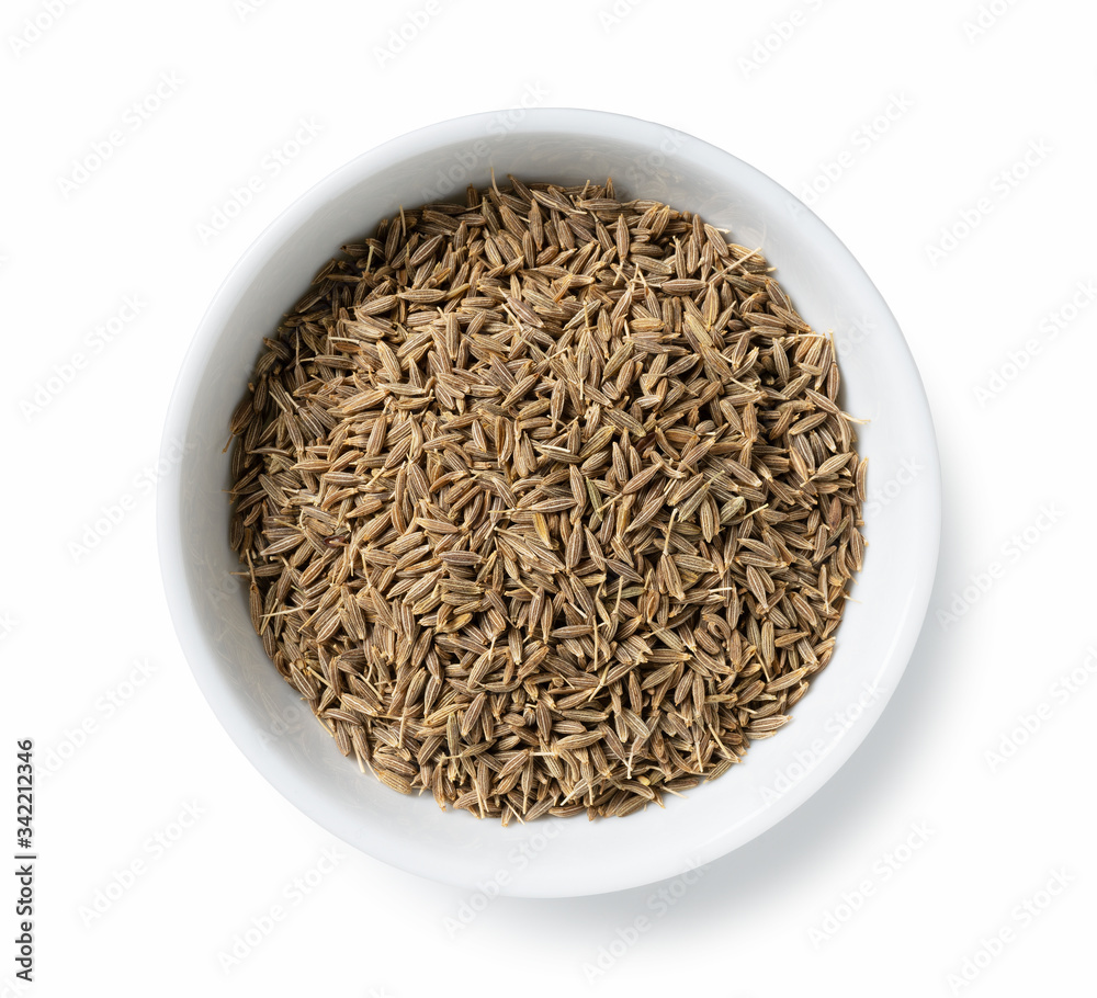 Cumin seeds in a plate placed on a white background