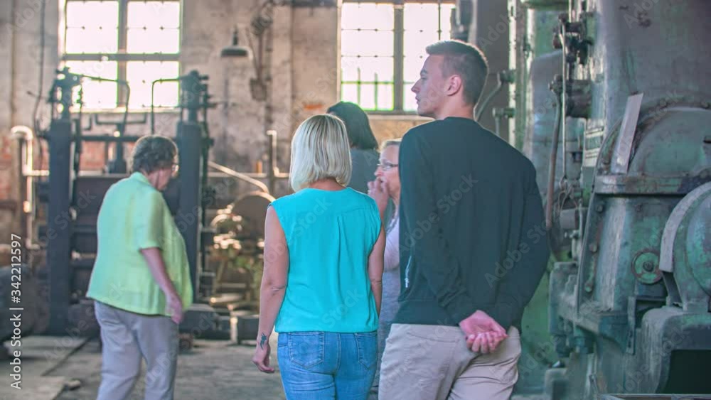 guide and group of visitors walk into blacksmith’s workshop, Ironmaking Museum guide and group of visitors walk into blacksmith’s workshop, Ironmaking Museum