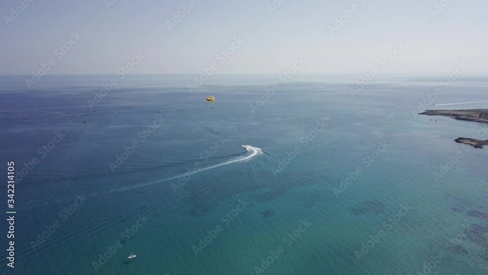 flying drone on a kind of parachutist with a motorboat by the sea flying drone on a kind of parachutist with a motorboat by the sea