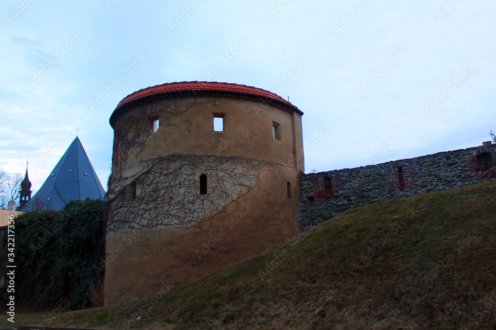 Part of the old castle with a large stone tower and part of the wall 