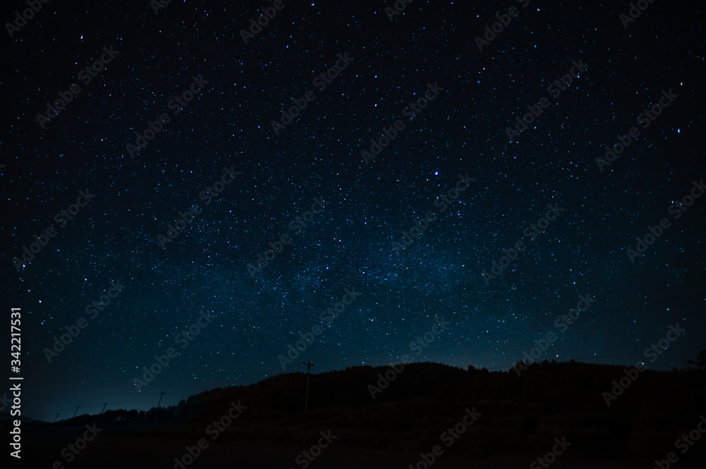Starry sky on a background of a slope, night landscape. Astrology, horoscopes, astro screensaver, space