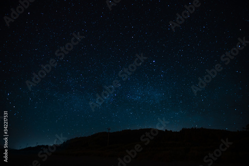 Starry sky on a background of a slope, night landscape. Astrology, horoscopes, astro screensaver, space