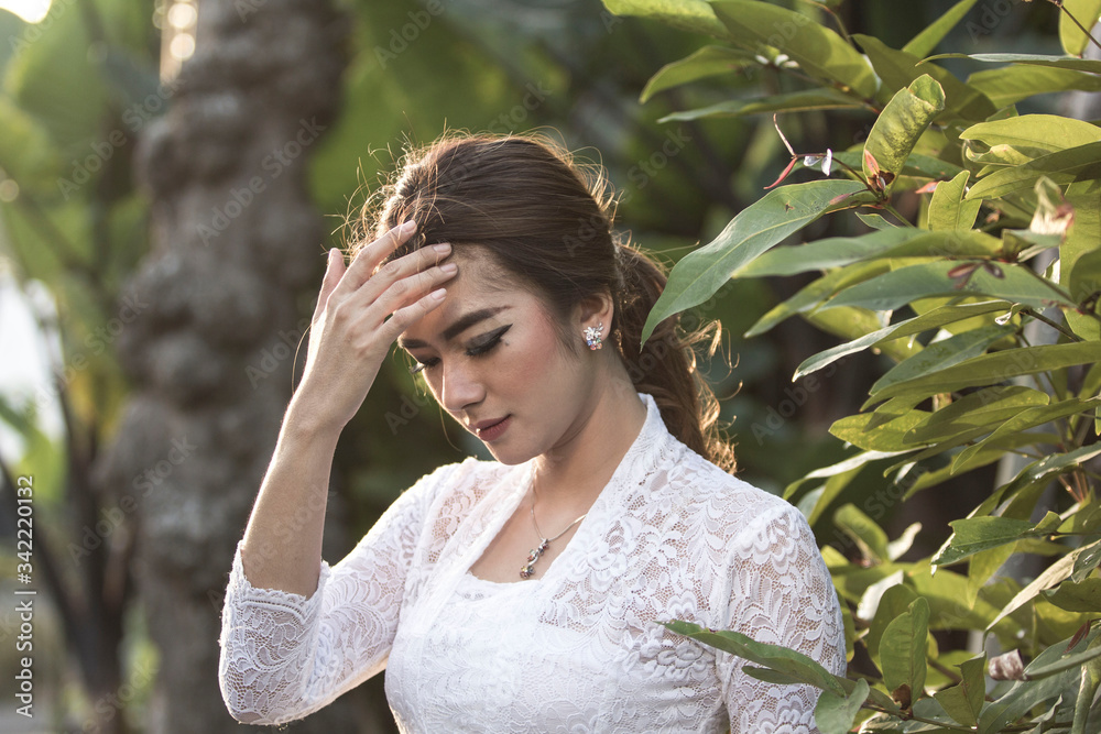 Portrait of beautiful south east asian woman wearing jewelry and white traditional cloth.Calm face expression medium close up photography. Portrait of beautiful south east asian woman wearing jewelry and white traditional cloth.Calm face expression medium close up photography.