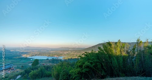 High view Time lapse Landscape Sunrise with mountain, hill with trees, blue sky with mist.