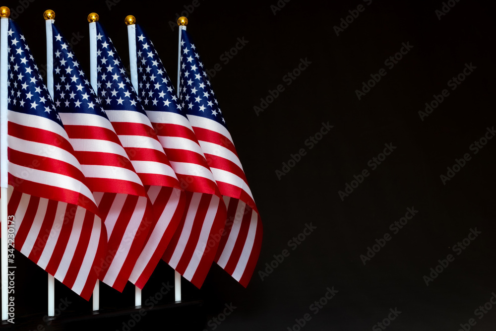 Desktop flags of USA on black background with copy space. Concept of the patriotic holidays