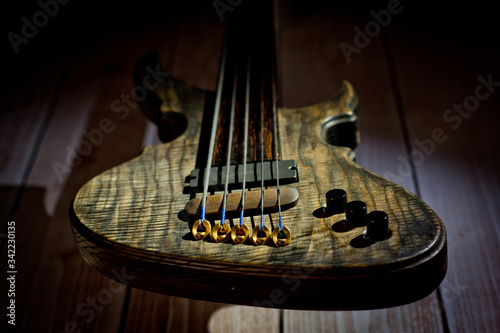 Five-string electric dark wood bass. Background for music and creativity. photo