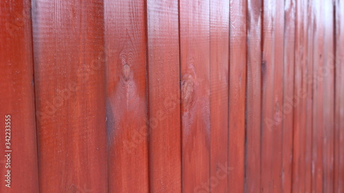 lacquered mahogany fence at an angle in linear perspective