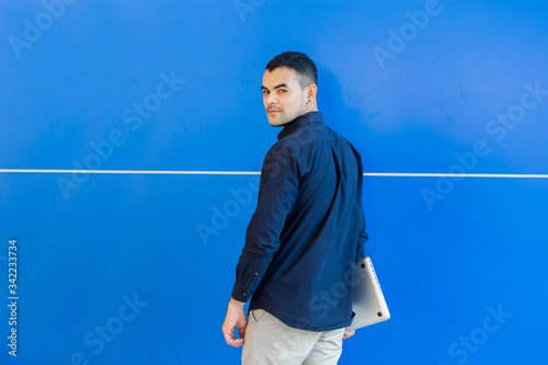 young asian business man, Happy young man working on laptop,at his working from home,Mock up copy space,On a blue background