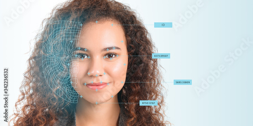 Quadro em tela Young businesswoman using facial recognition system for data protection