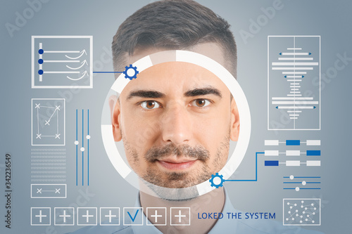 Young businessman using fac...