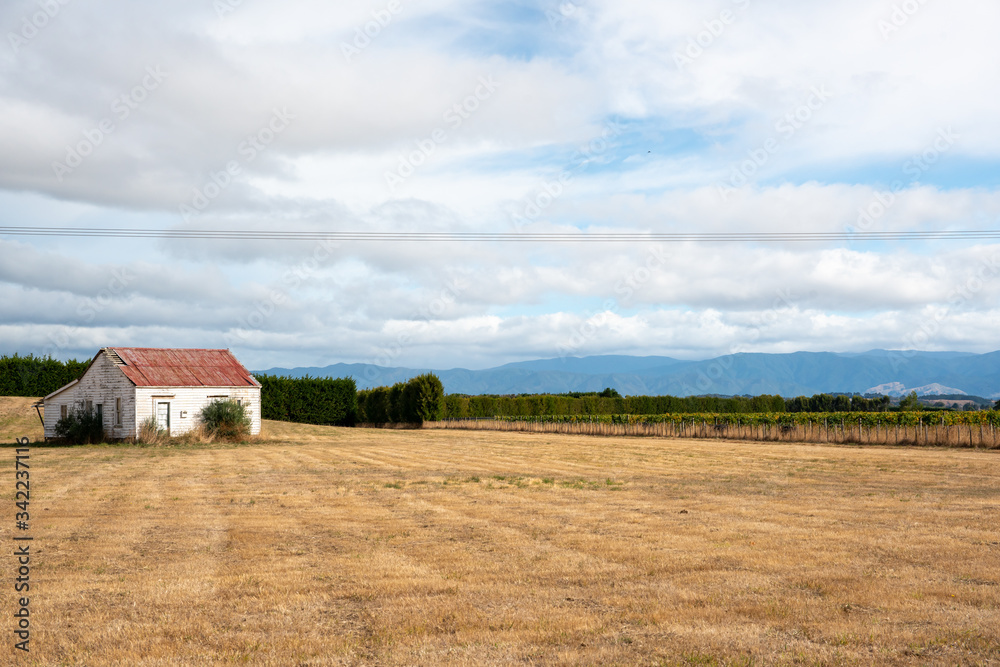 Dilapidated old wooden barn in the paddock on a rural farm in the country Dilapidated old wooden barn in the paddock on a rural farm in the country