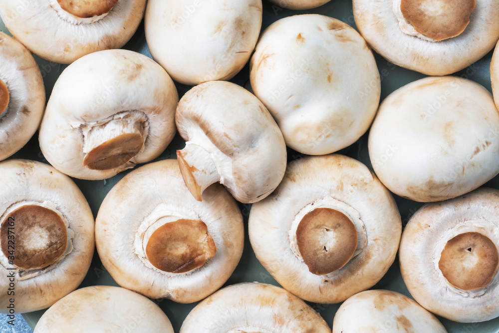 Raw champignons texture. Background of mushrooms Close up. Raw champignons texture. Background of mushrooms Close up.
