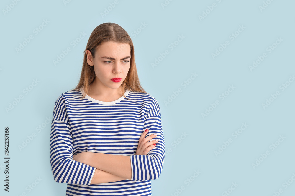 Offended young woman on color background Offended young woman on color background