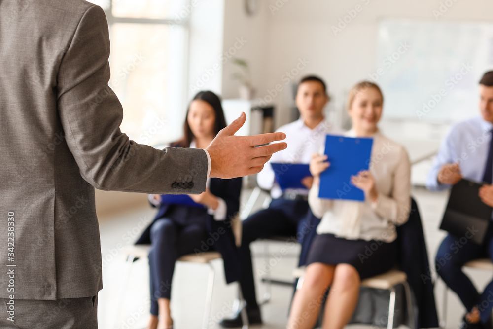 Businessman giving presentation in office Businessman giving presentation in office