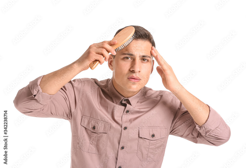 Handsome young man brushing hair on white background Handsome young man brushing hair on white background
