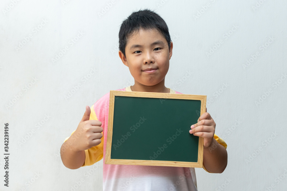 Asian boy holding empty board. Concept of education Asian boy holding empty board. Concept of education