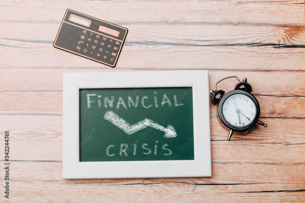charts of economics and stock markets on a chalk board. financial crisis concept. charts of economics and stock markets on a chalk board. financial crisis concept.