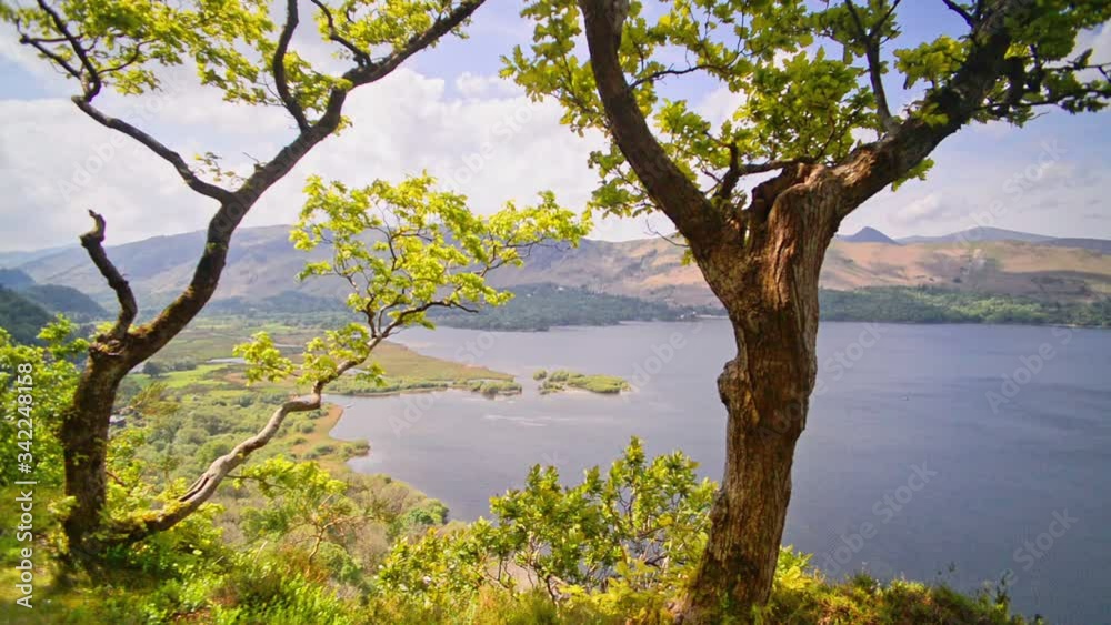 Beautiful Scenery From The Green Mountains Overlooking The Serene Water At Lake District In Cumbria, England .- wide shot Beautiful Scenery From The Green Mountains Overlooking The Serene Water At Lake District In Cumbria, England .- wide shot