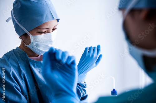 医療用防護服を着た医療従事者が手袋をはめている photo