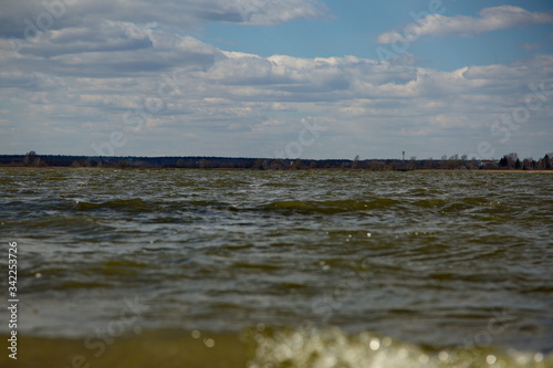 Water surface of a forest lake in windy weather.